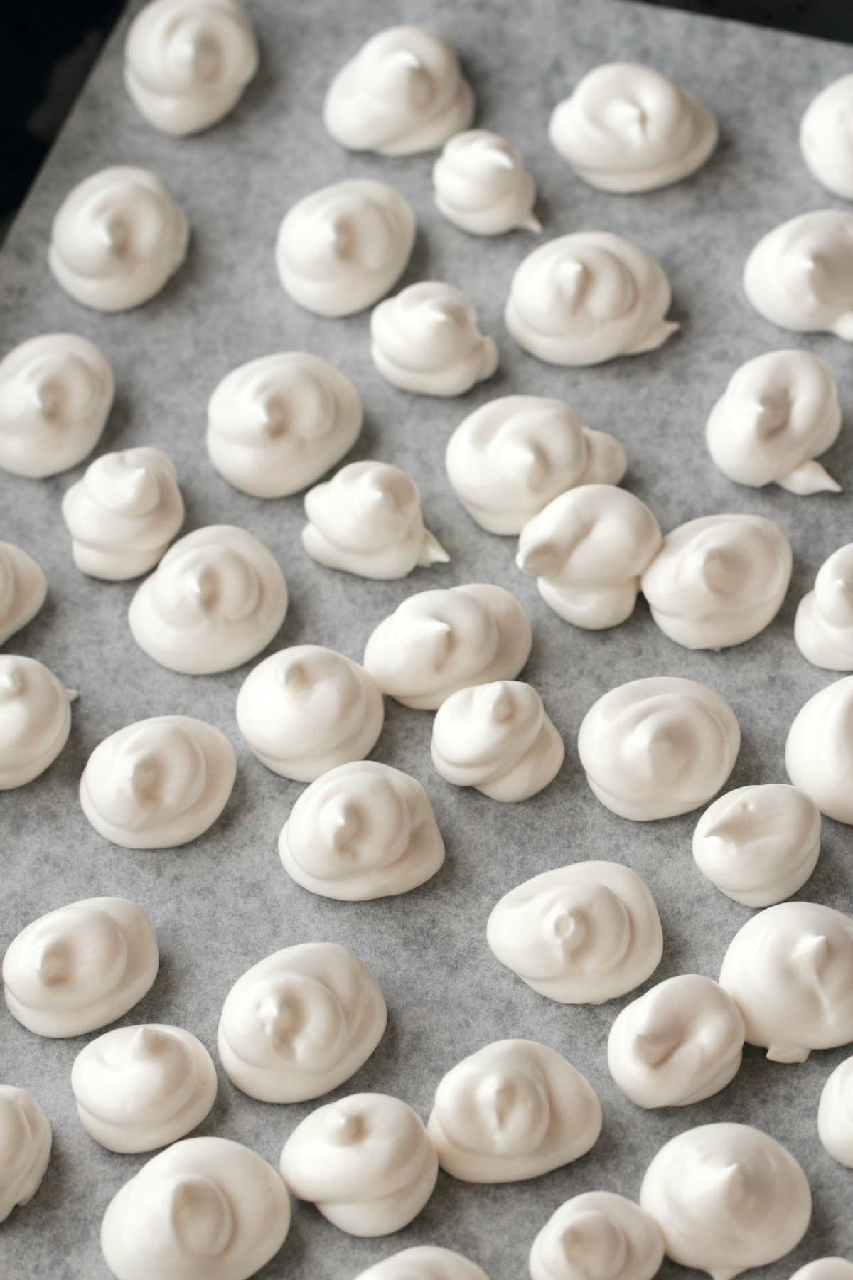 Vegan Meringue freshly piped onto a baking tray and ready to go into the oven. 