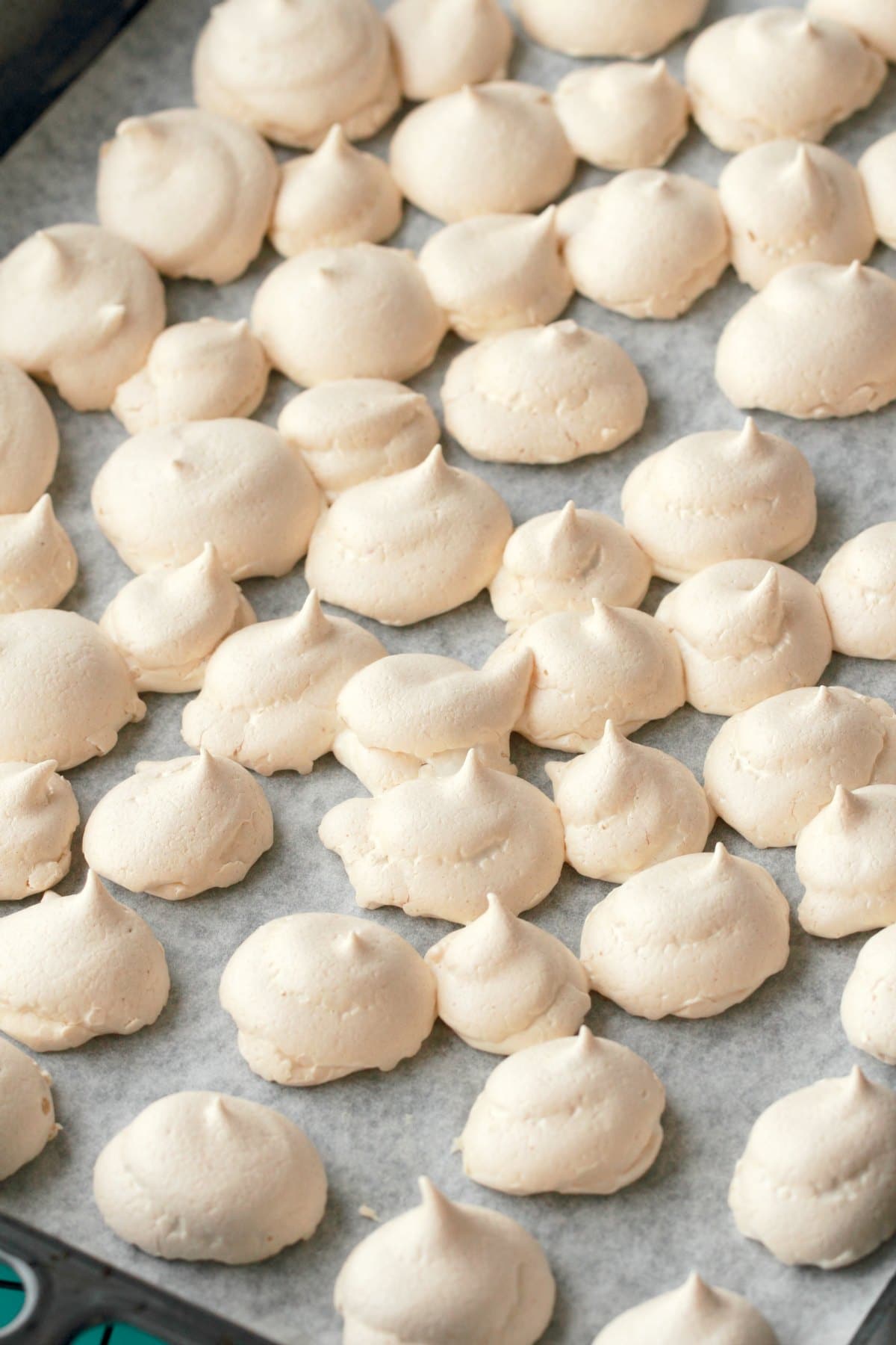 Vegan Meringue cookies on a baking tray straight out of the oven. 