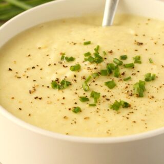 Vegan potato leek soup in a white bowl.