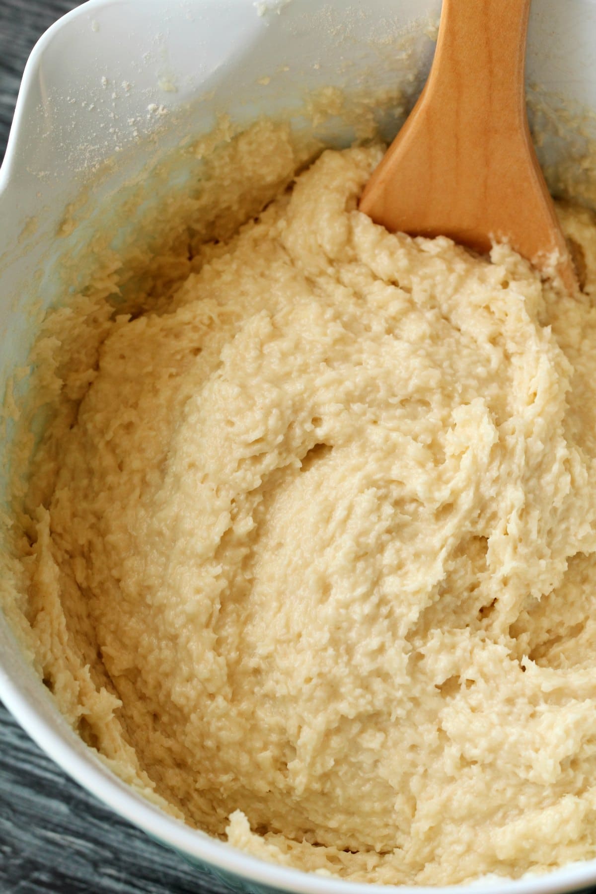 Batter for coconut cake in a white mixing bowl. 