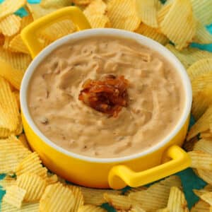 Vegan onion dip in a white and yellow bowl.