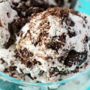 Scoops of vegan cookies and cream ice cream in a glass bowl.