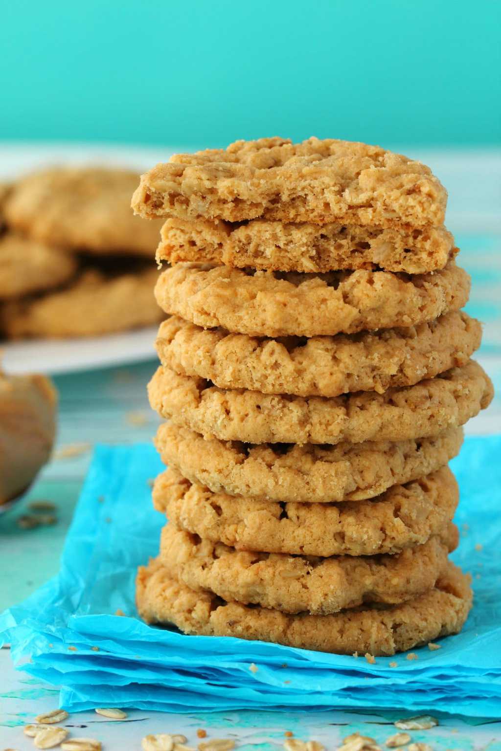 Vegan Peanut Butter Oatmeal Cookies in a stack, the top cookie broken in half. 