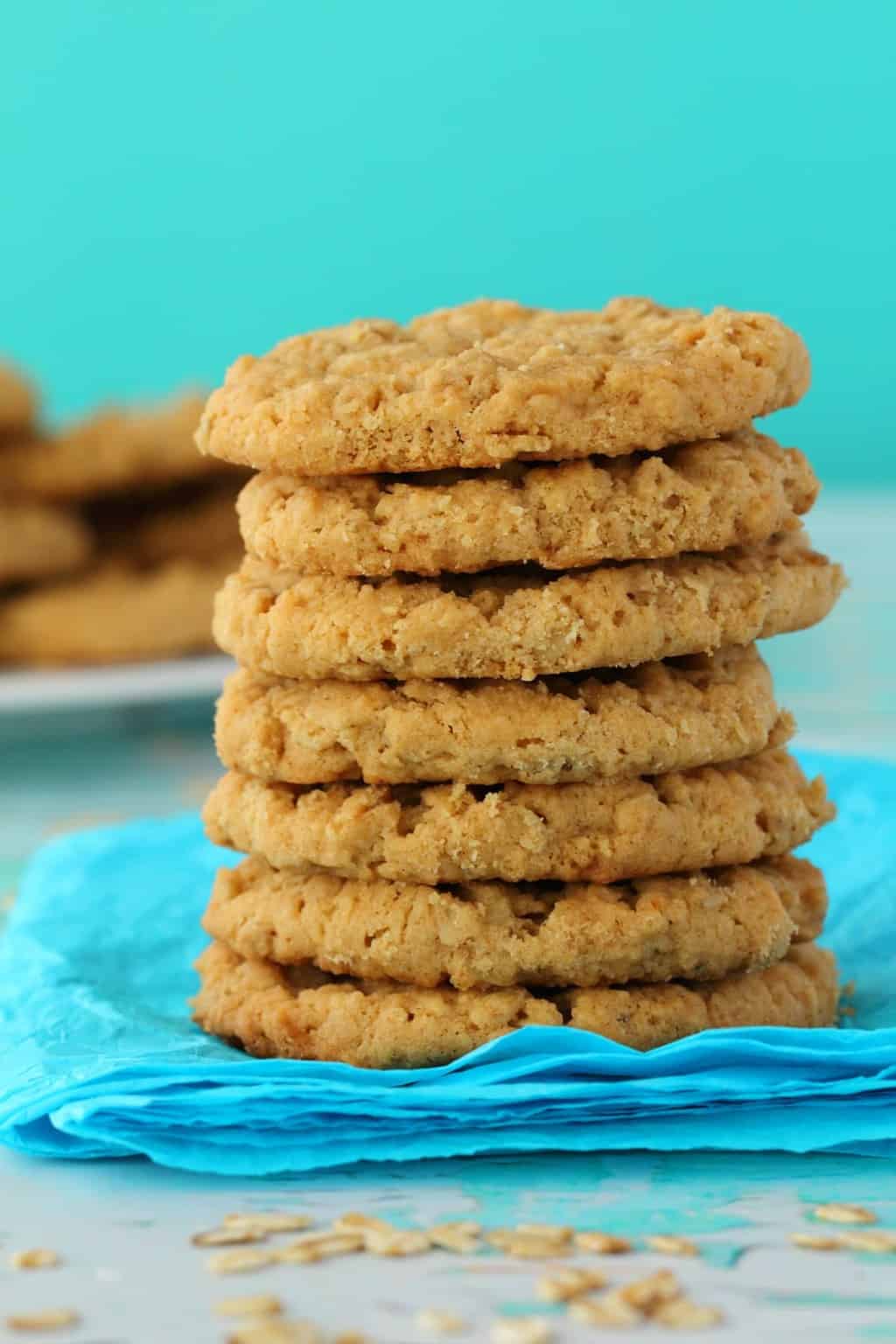 Vegan Peanut Butter Oatmeal Cookies in a stack against a blue background. 