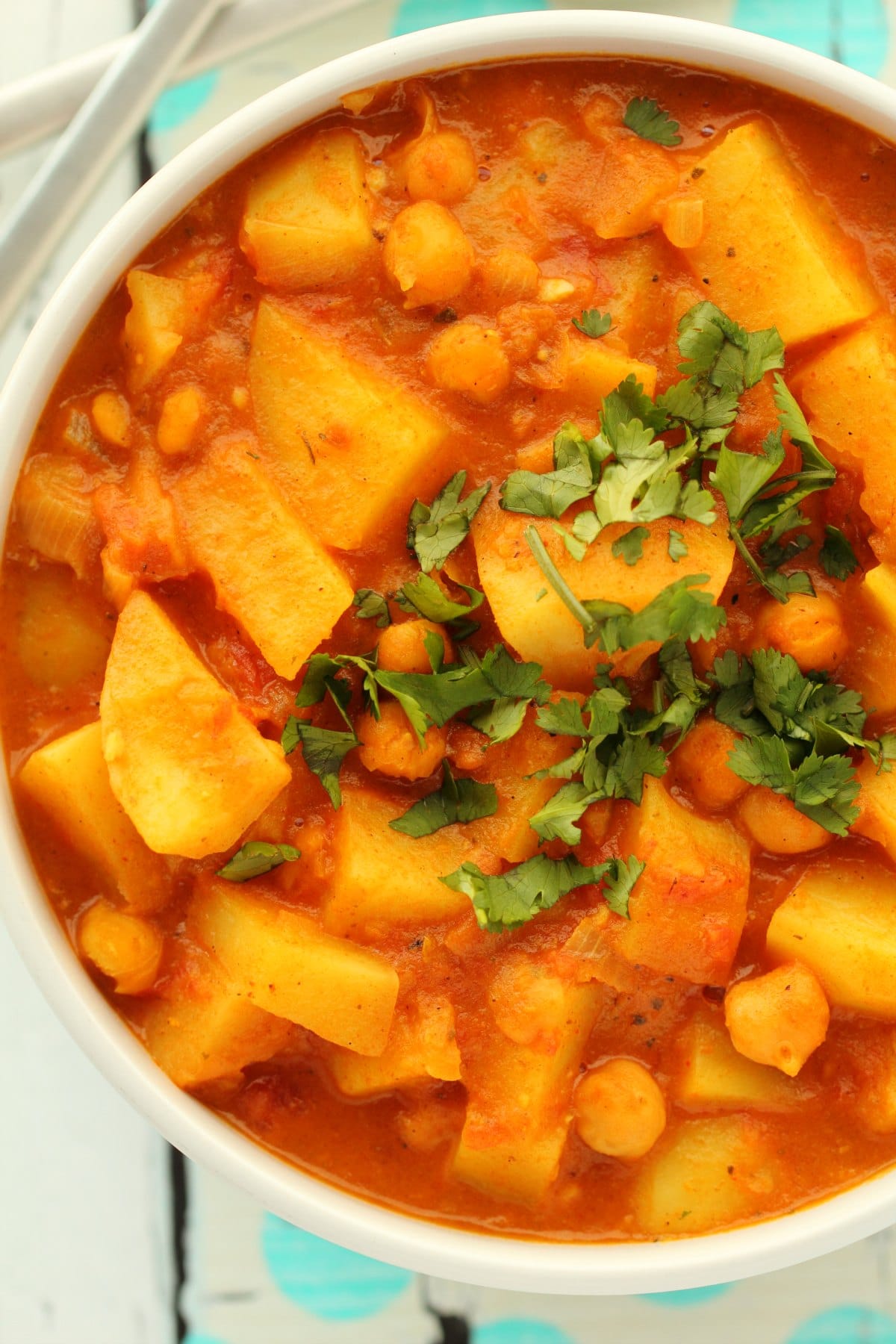 Vegan potato curry in a white bowl. 
