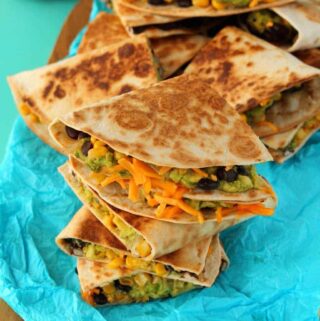 Vegan quesadillas stacked up on top of each other.