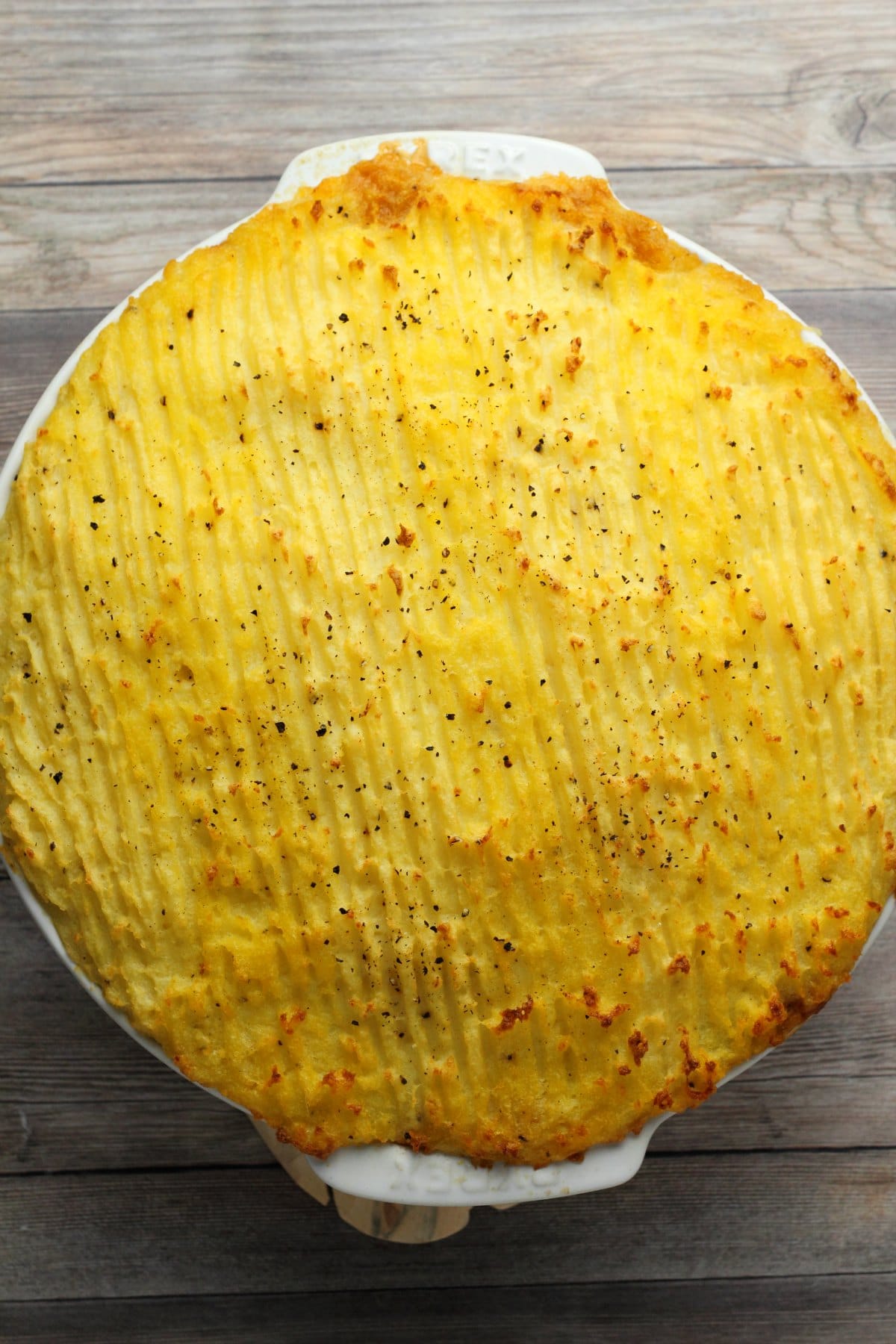 Vegan Shepherd's Pie in a white pie dish, straight out of the oven. 