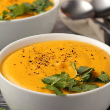 Vegan sweet potato soup in white bowls.