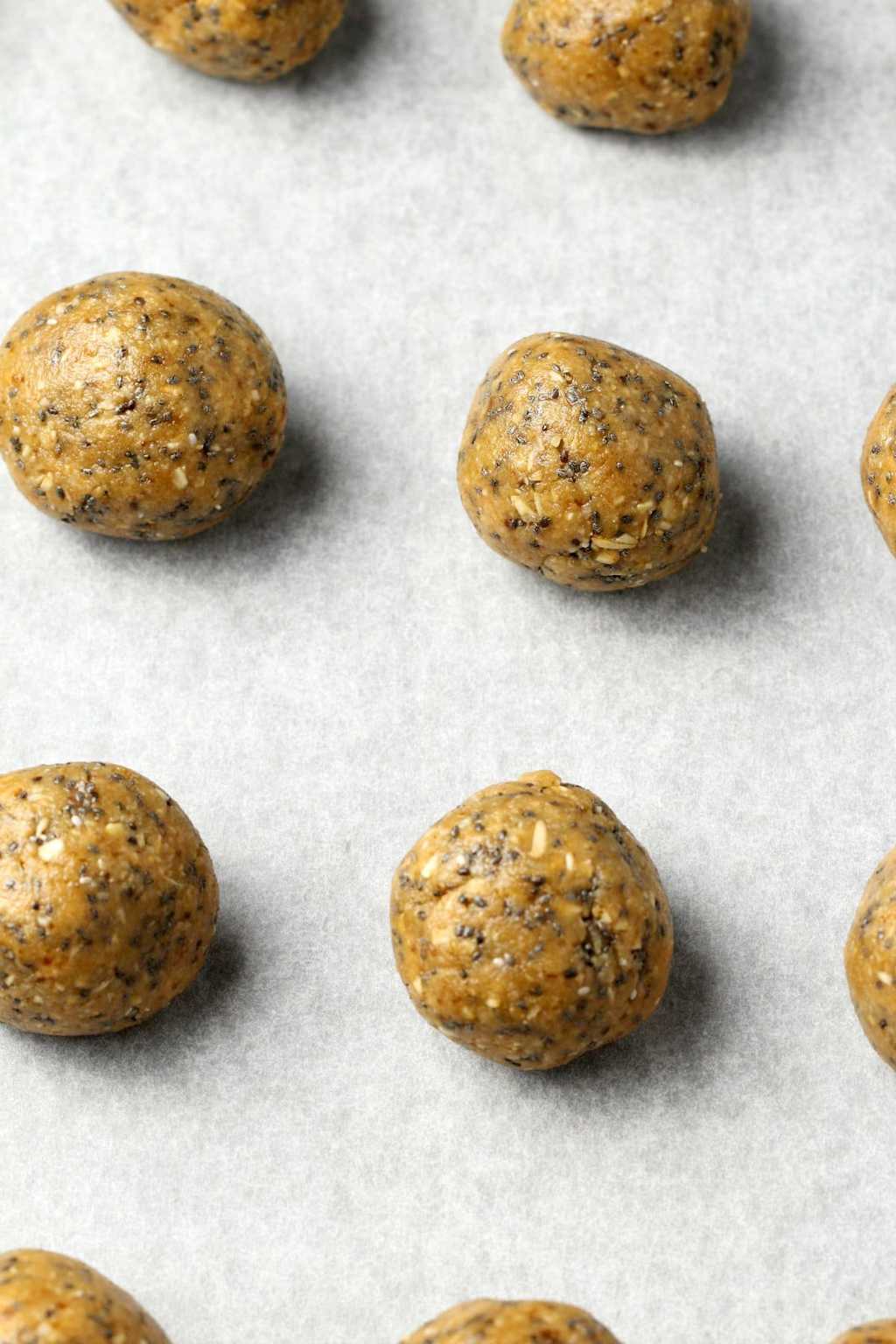 Vegan energy balls on a parchment lined tray. 