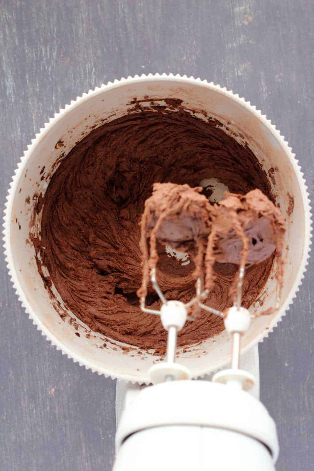 Chocolate buttercream frosting in a stand mixer. 