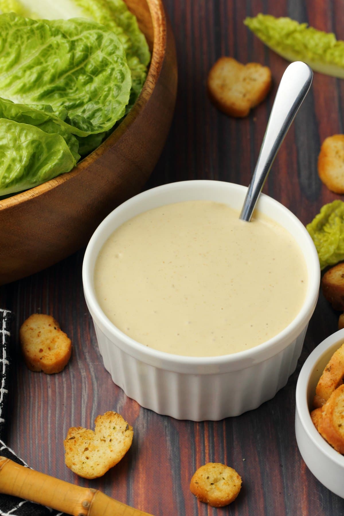 Vegan caesar dressing in a white bowl with a spoon. 