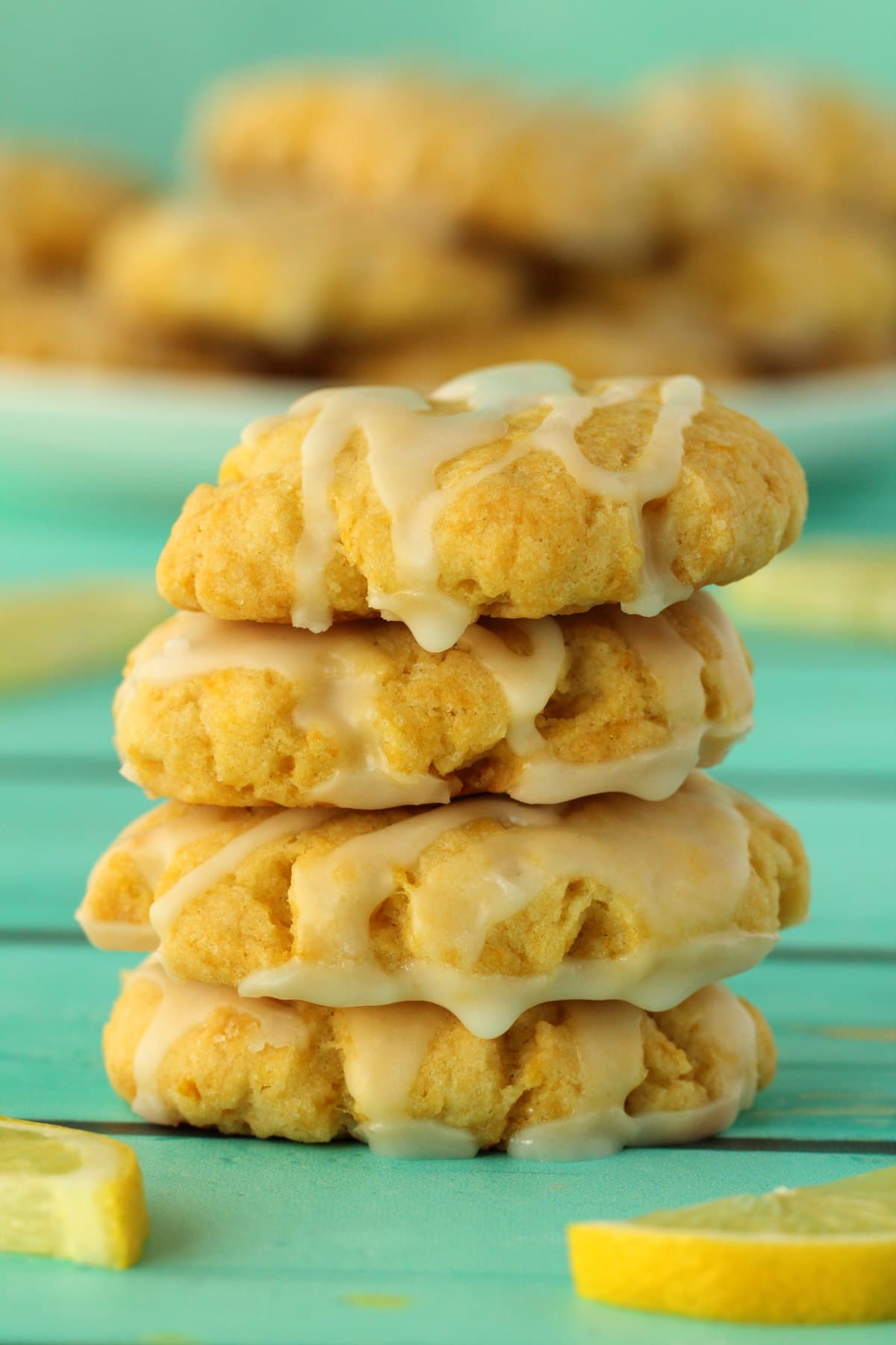 Vegan lemon cookies stacked up on top of each other. 
