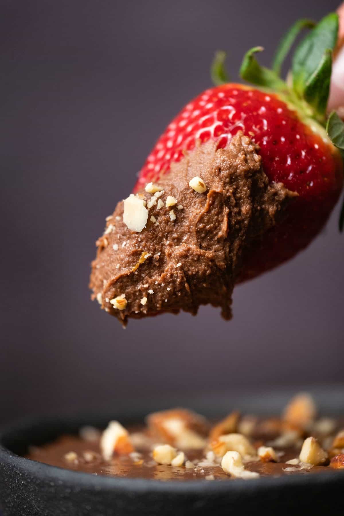 Strawberry dipped into chocolate hummus. 