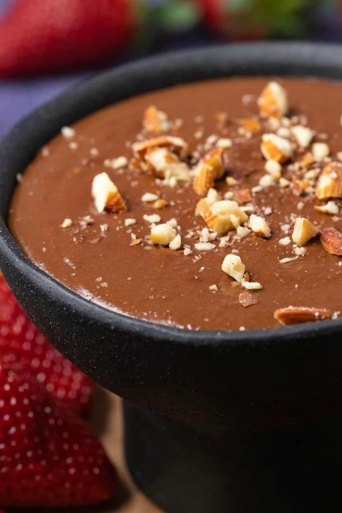 Chocolate hummus in a black bowl.