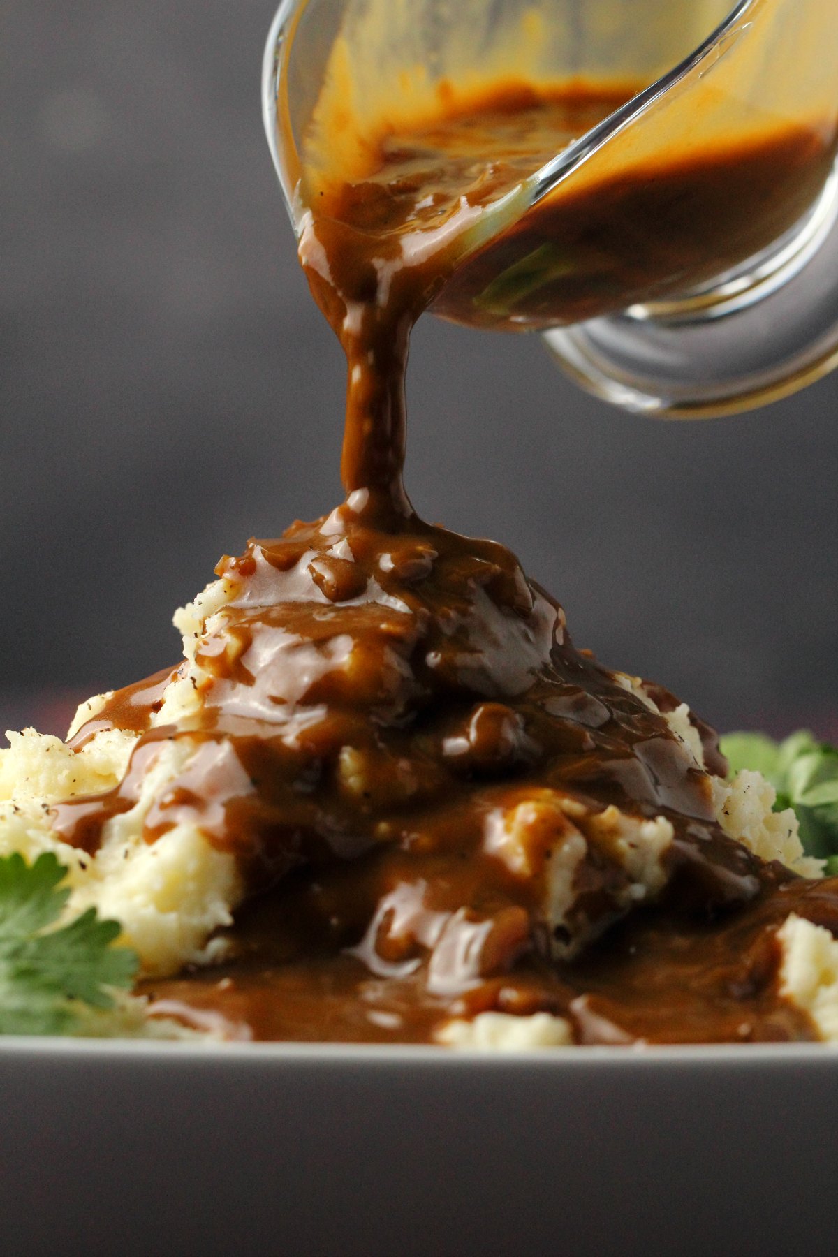Gravy pouring over mashed potatoes. 