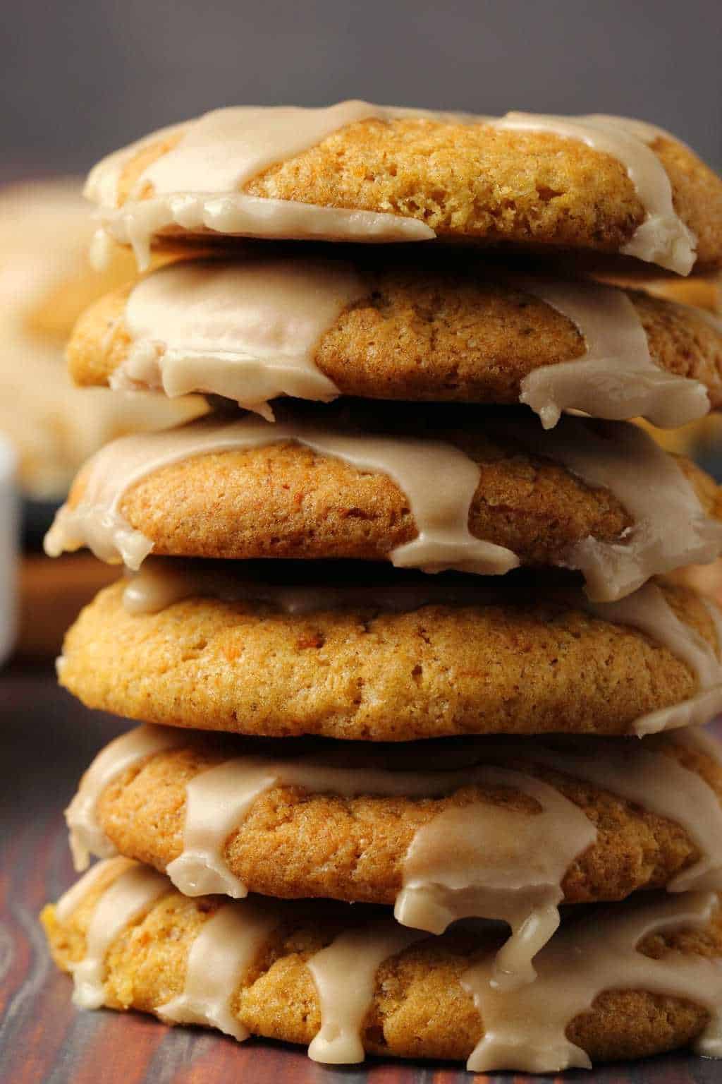 A stack of vegan pumpkin cookies topped with maple glaze. 