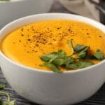 Vegan sweet potato soup in a white bowl.