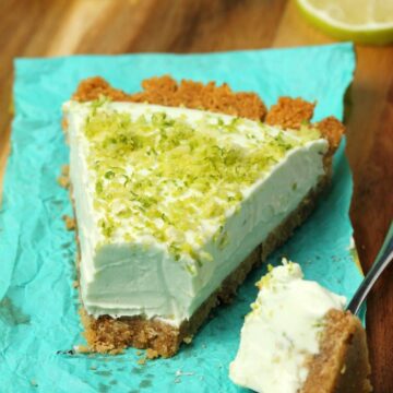 Slice of vegan key lime pie on a napkin with a cake fork.