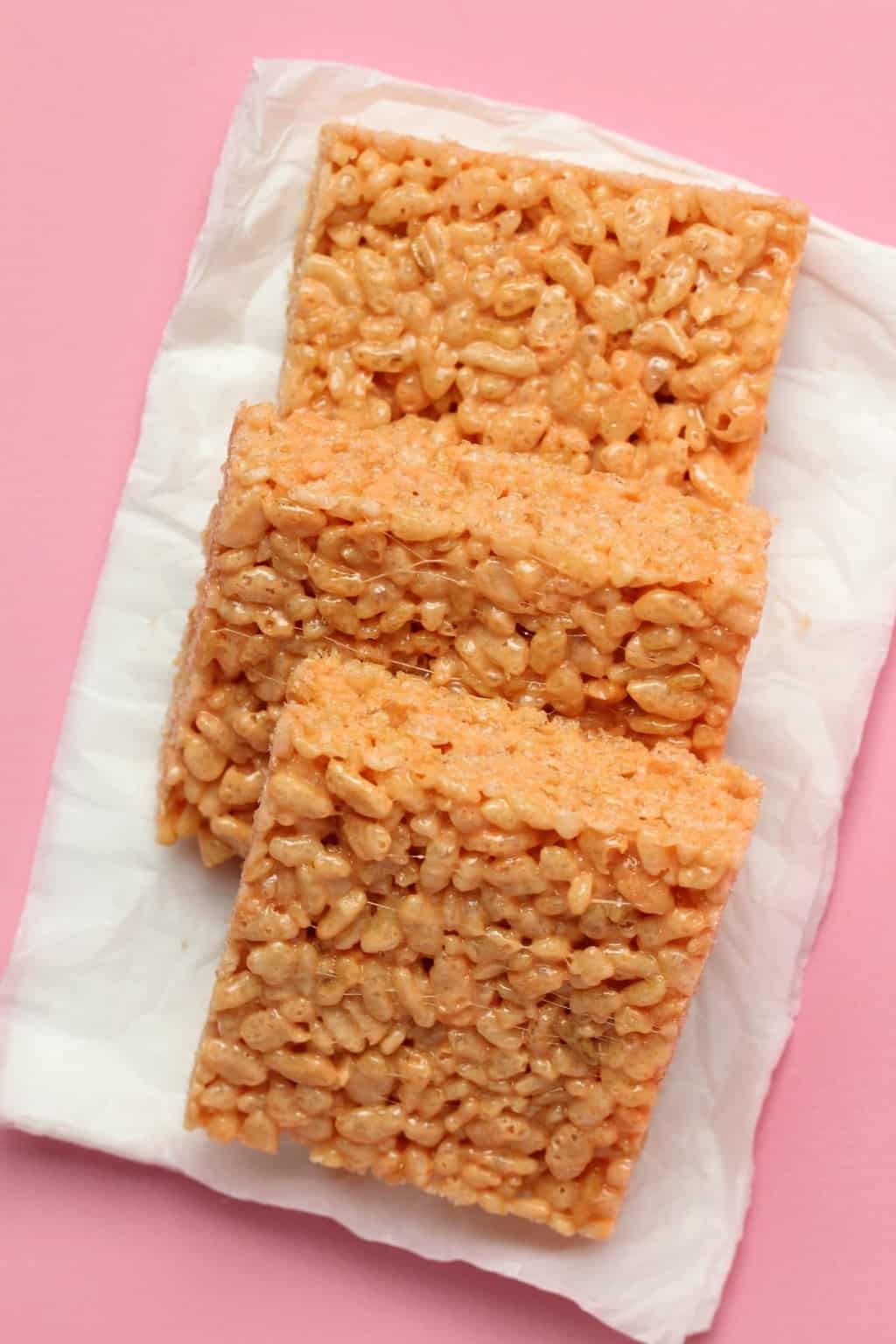 Vegan rice krispie treats in a row on white tissue paper. 
