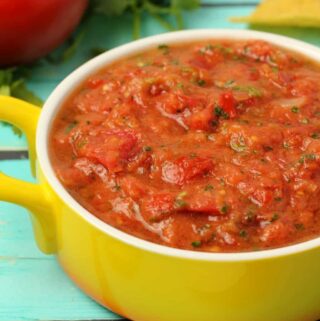 Homemade salsa in a yellow and white dish.