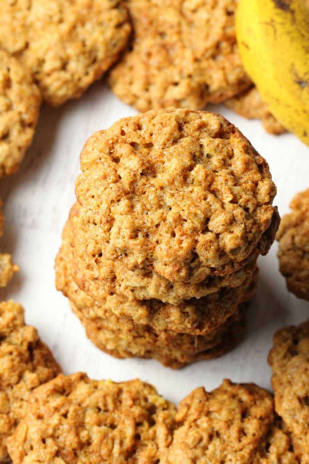 Vegan banana oatmeal cookies stacked up on top of each other. 