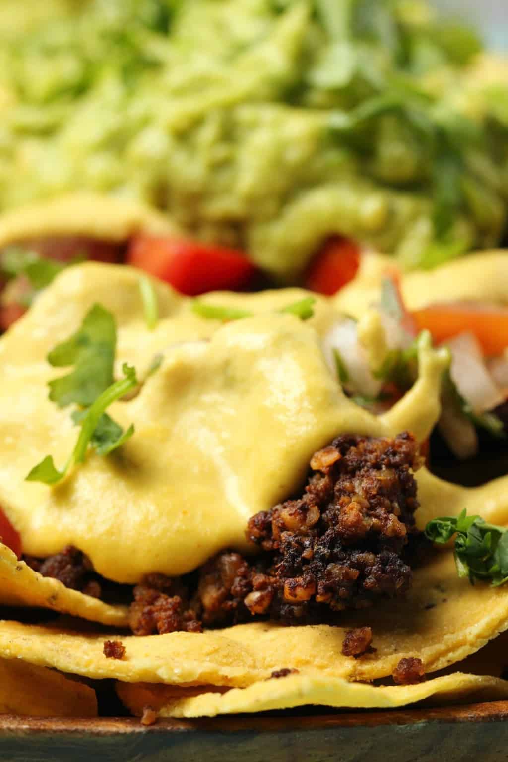 Fully loaded vegan nachos topped with vegan taco meat and vegan nacho cheese. 