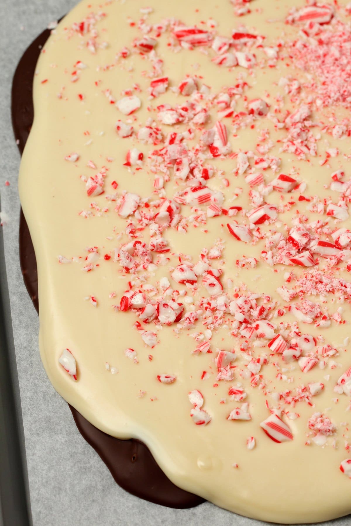 Vegan peppermint bark on a parchment lined baking tray. 