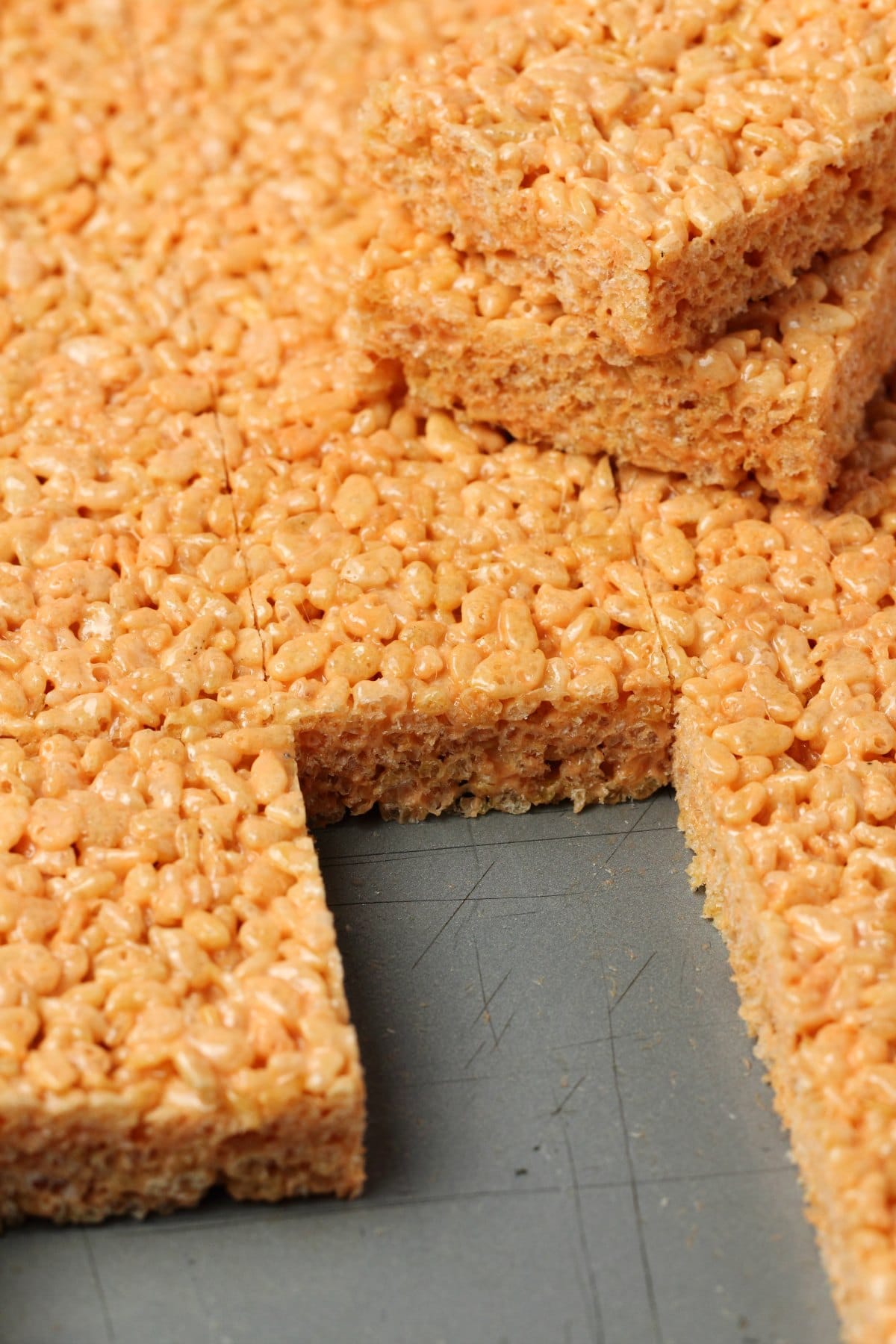 Vegan rice krispie treats in a 9x13 dish with a few squares removed.