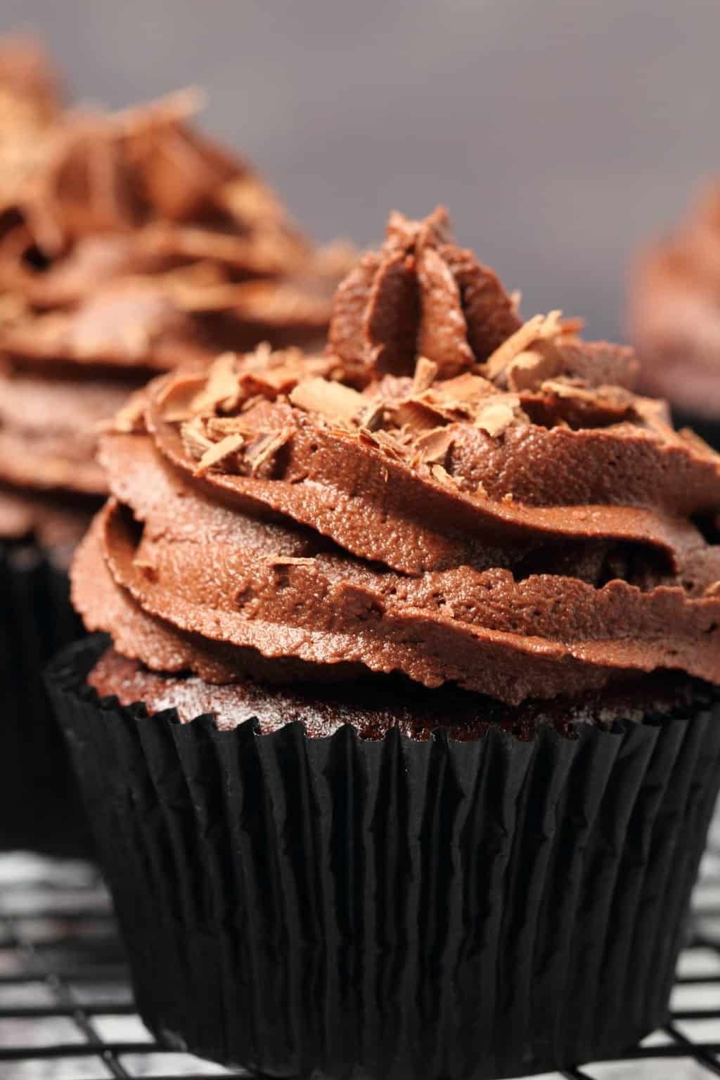 Classic vegan chocolate cupcakes topped with vegan chocolate buttercream and chocolate shavings.