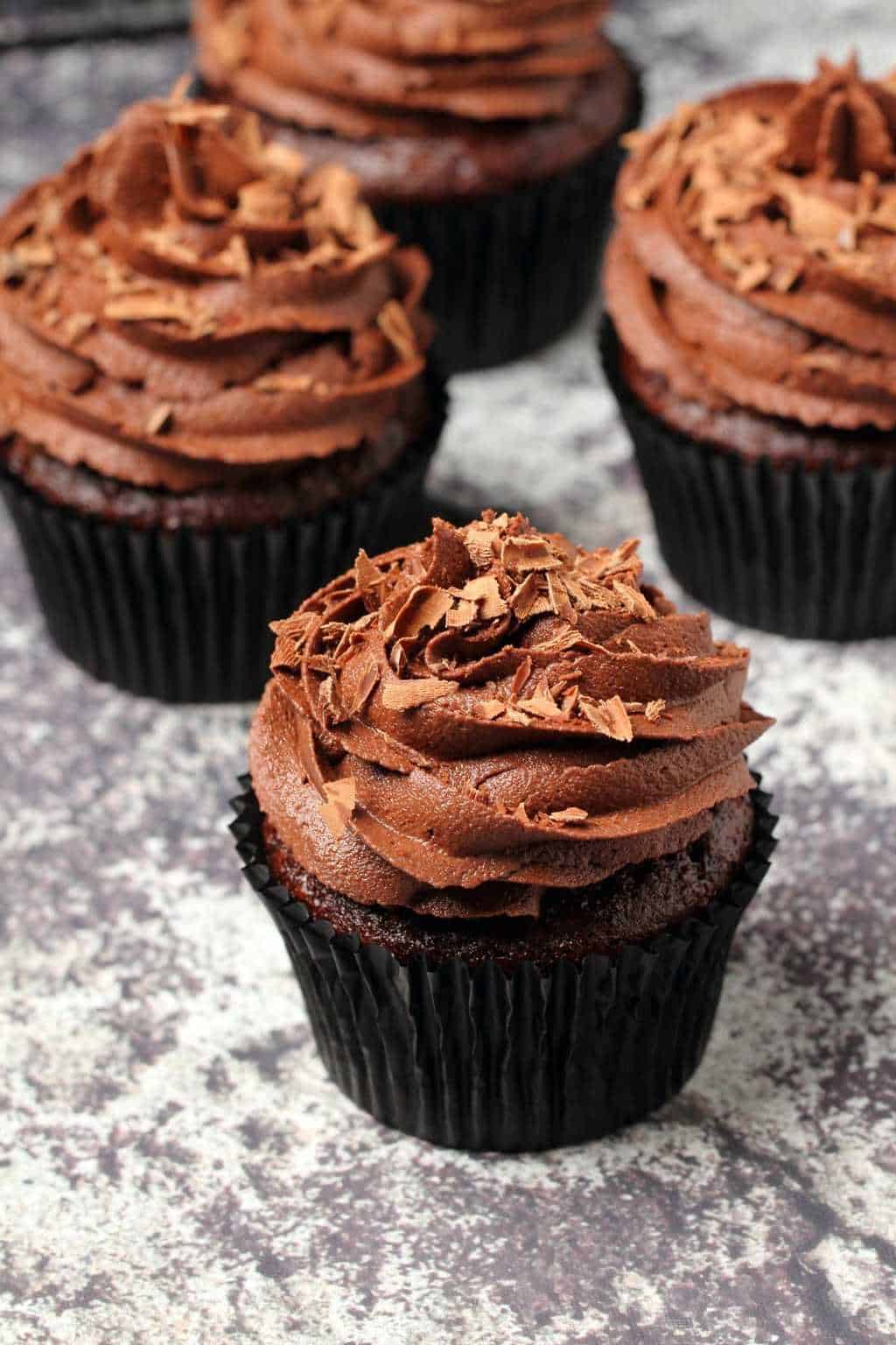 Classic vegan chocolate cupcakes topped with vegan buttercream and chocolate shavings. 