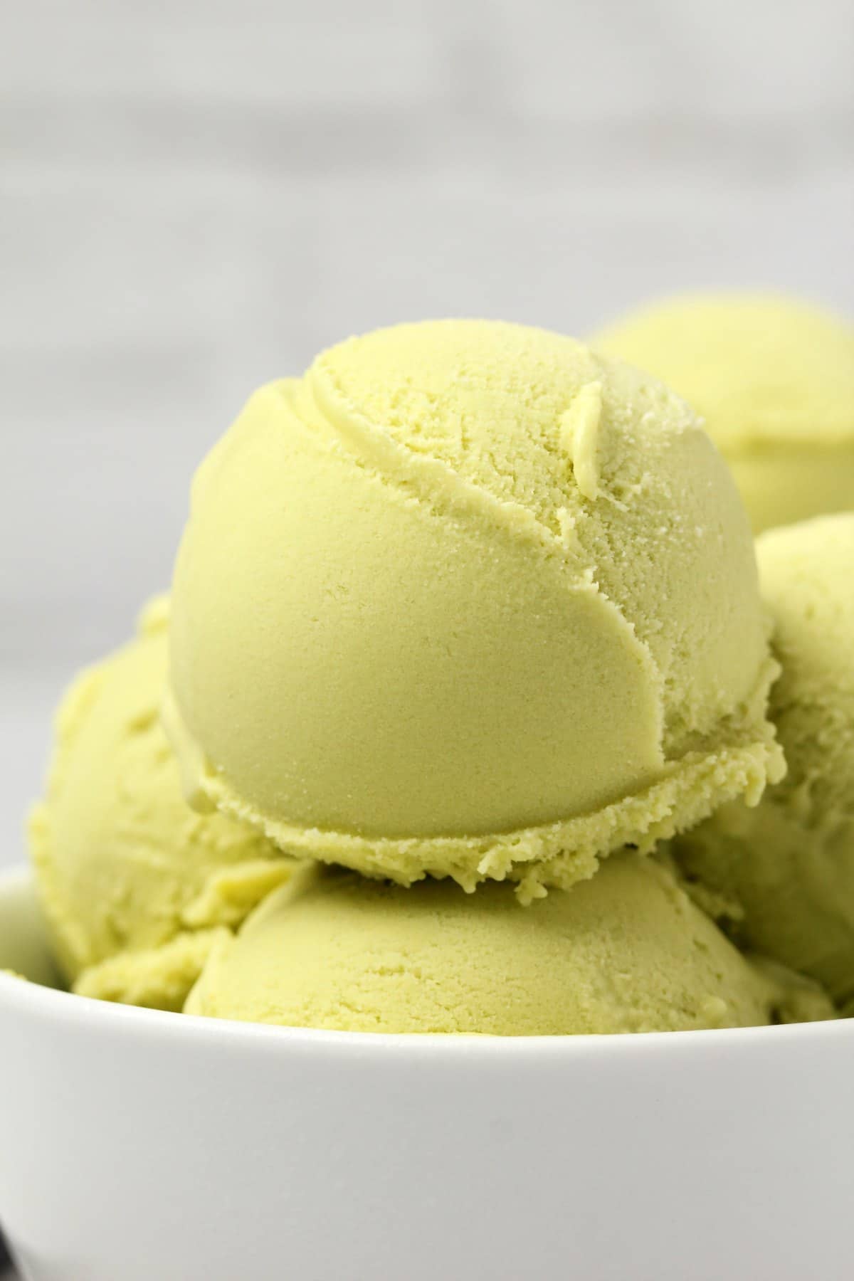 Vegan avocado ice cream in a white bowl. 