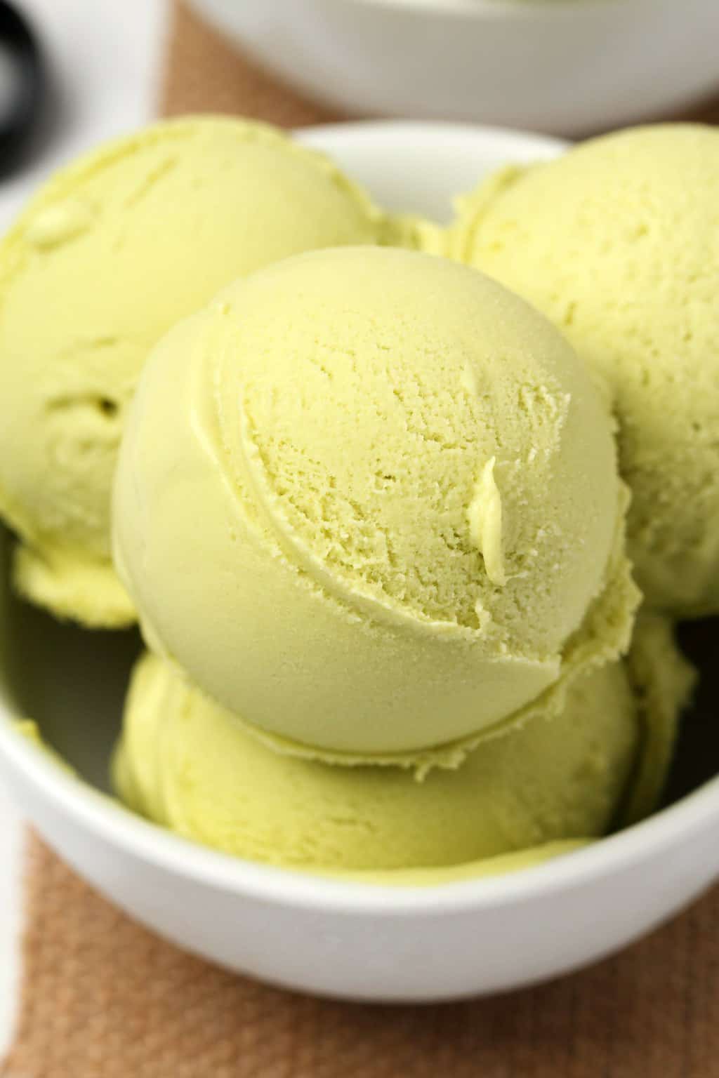 Vegan avocado ice cream in a white bowl. 