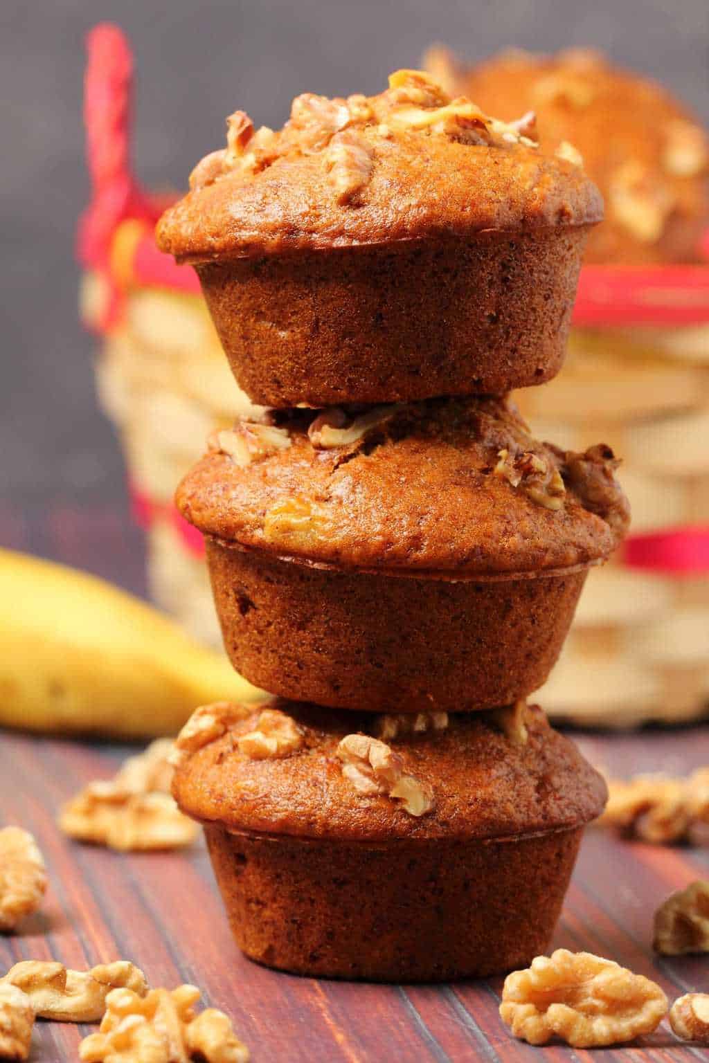 Vegan banana muffins stacked up on top of each other. 