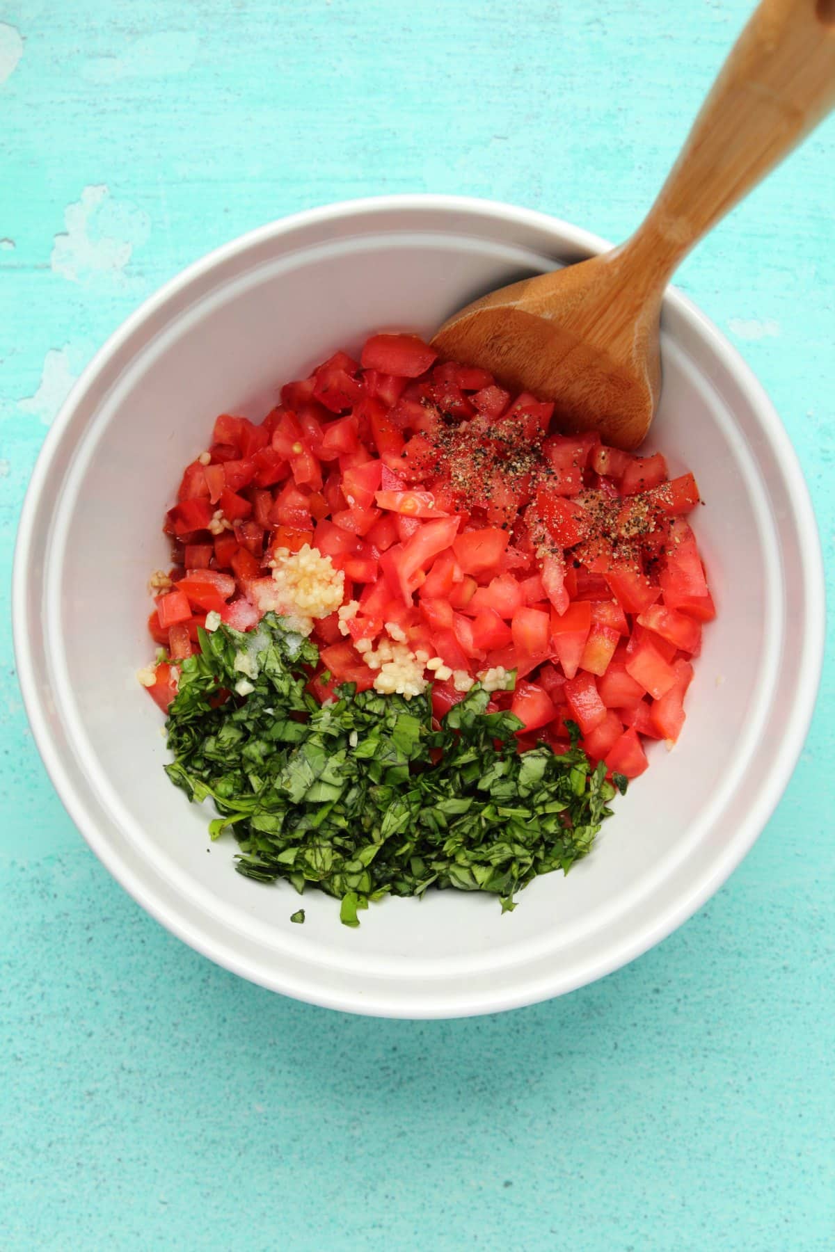 Ingredients for bruschetta topping added to mixing bowl. 