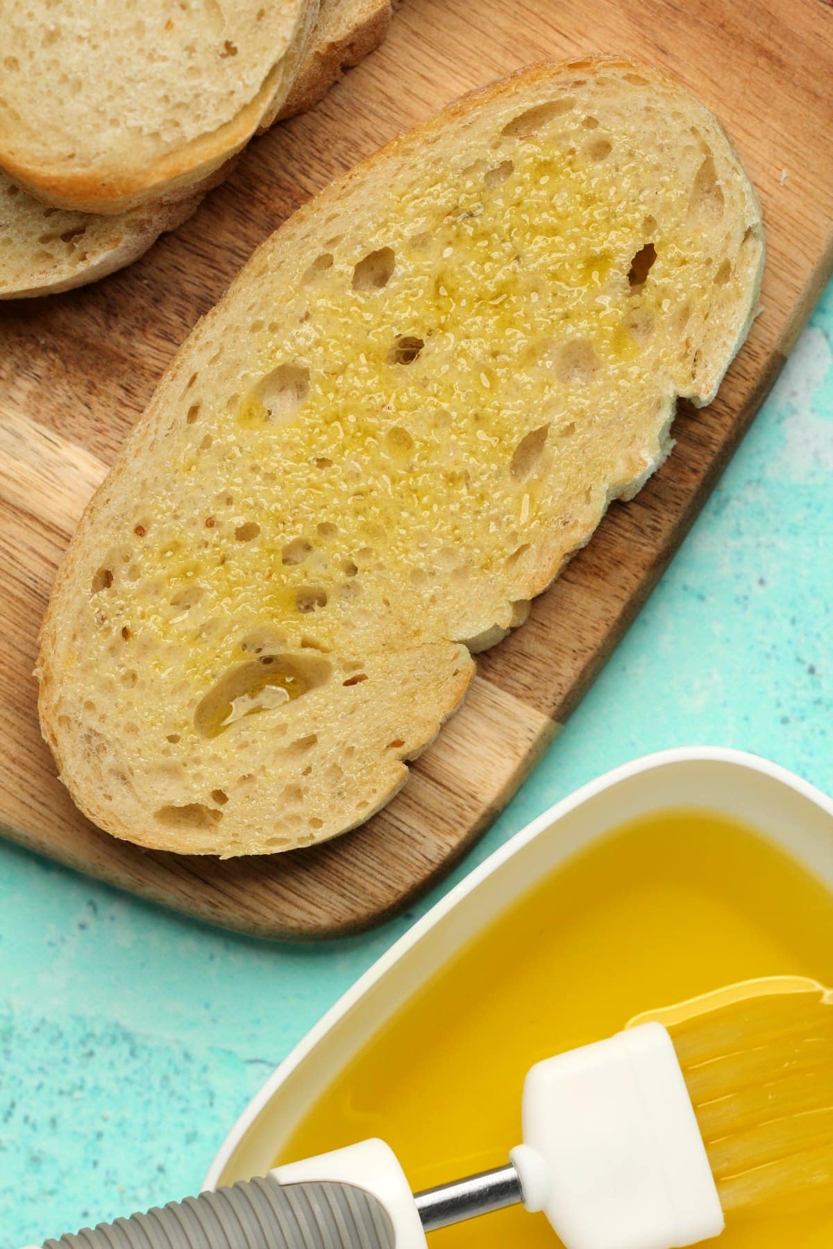 Brushing slices of ciabatta with olive oil. 