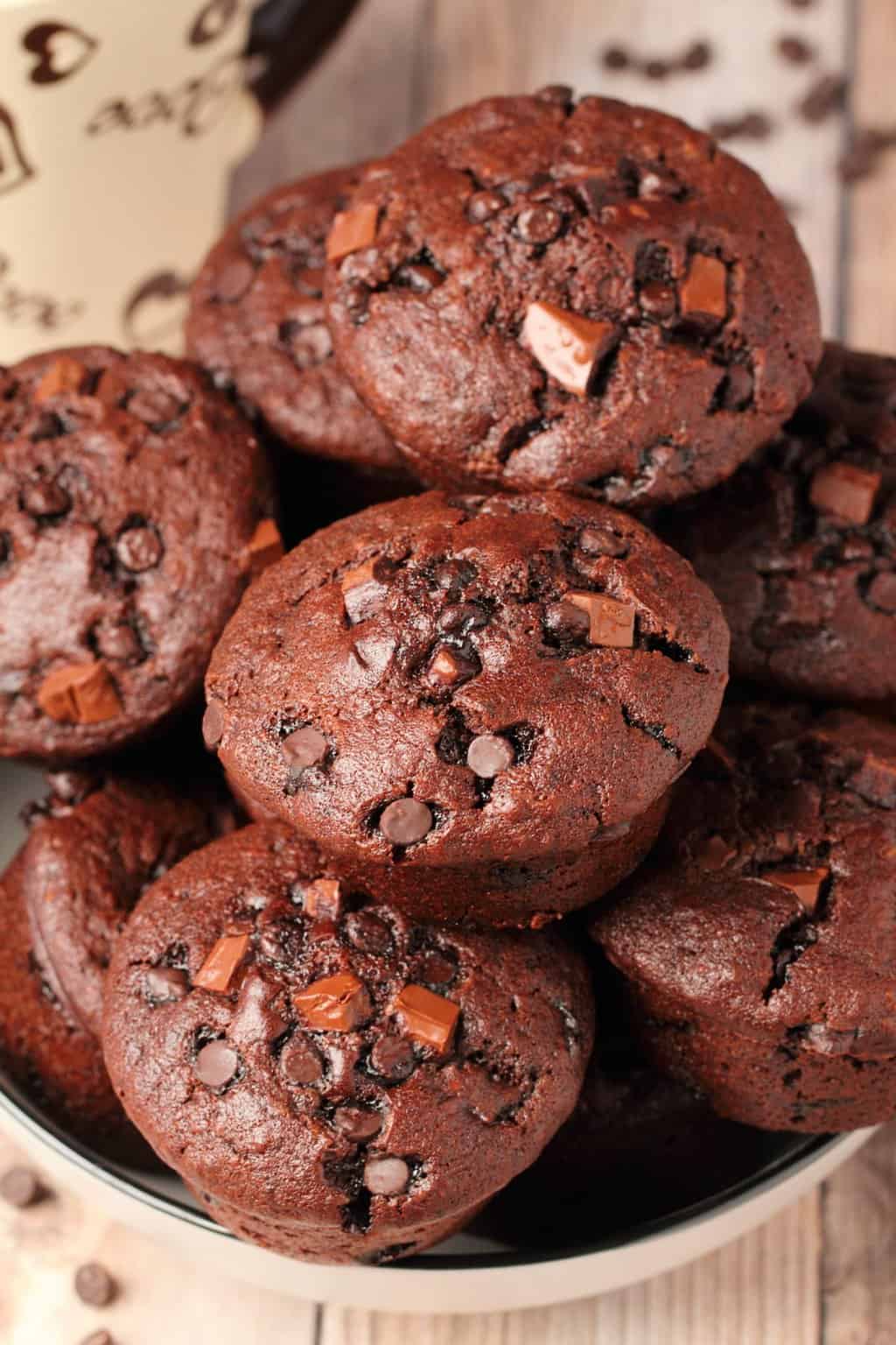 Vegan chocolate muffins stacked up in a stone bowl. 