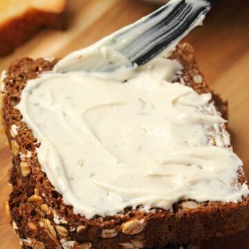 Vegan cream cheese spread on a slice of bread.
