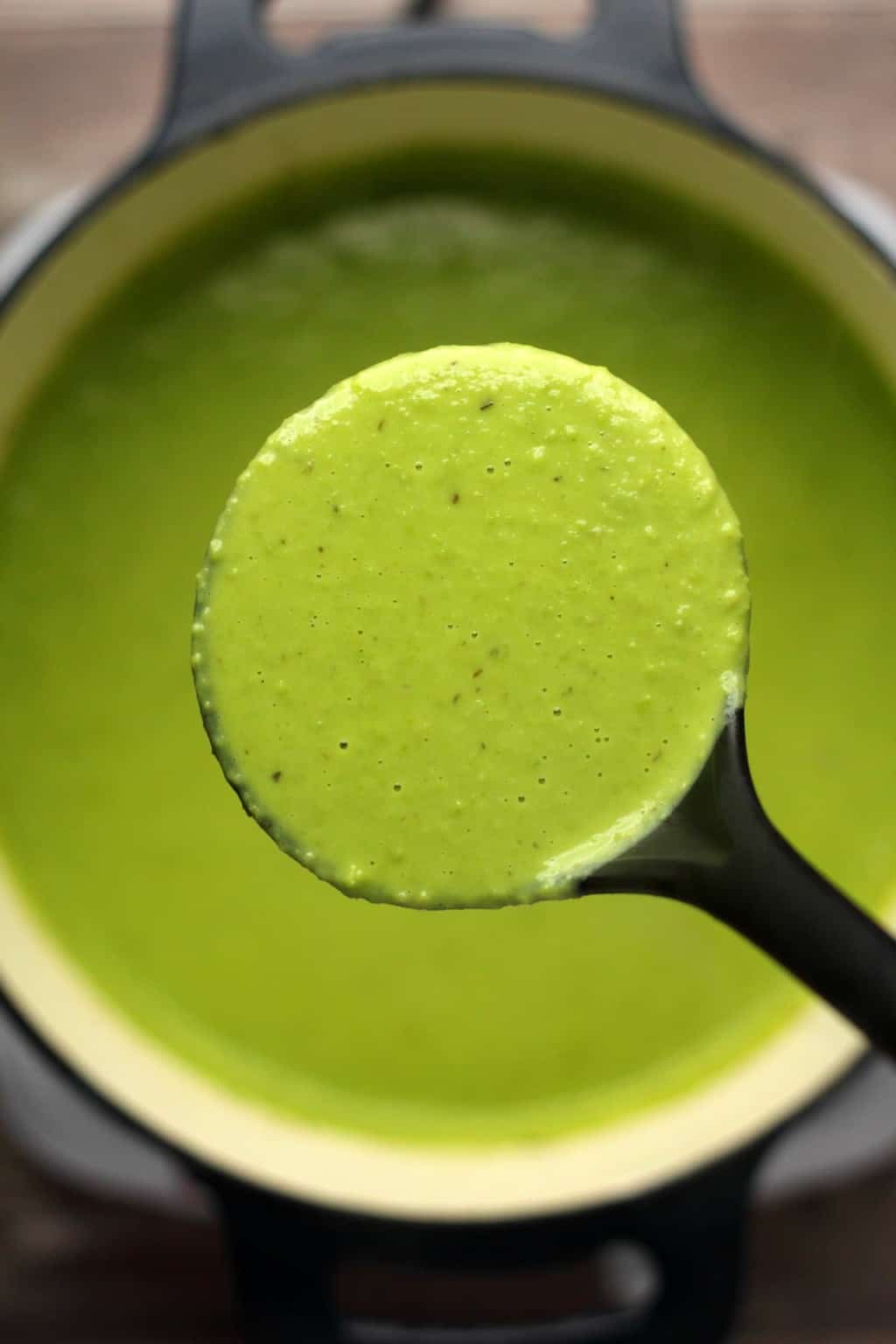 Pot of vegan pea soup with a soup ladle. 