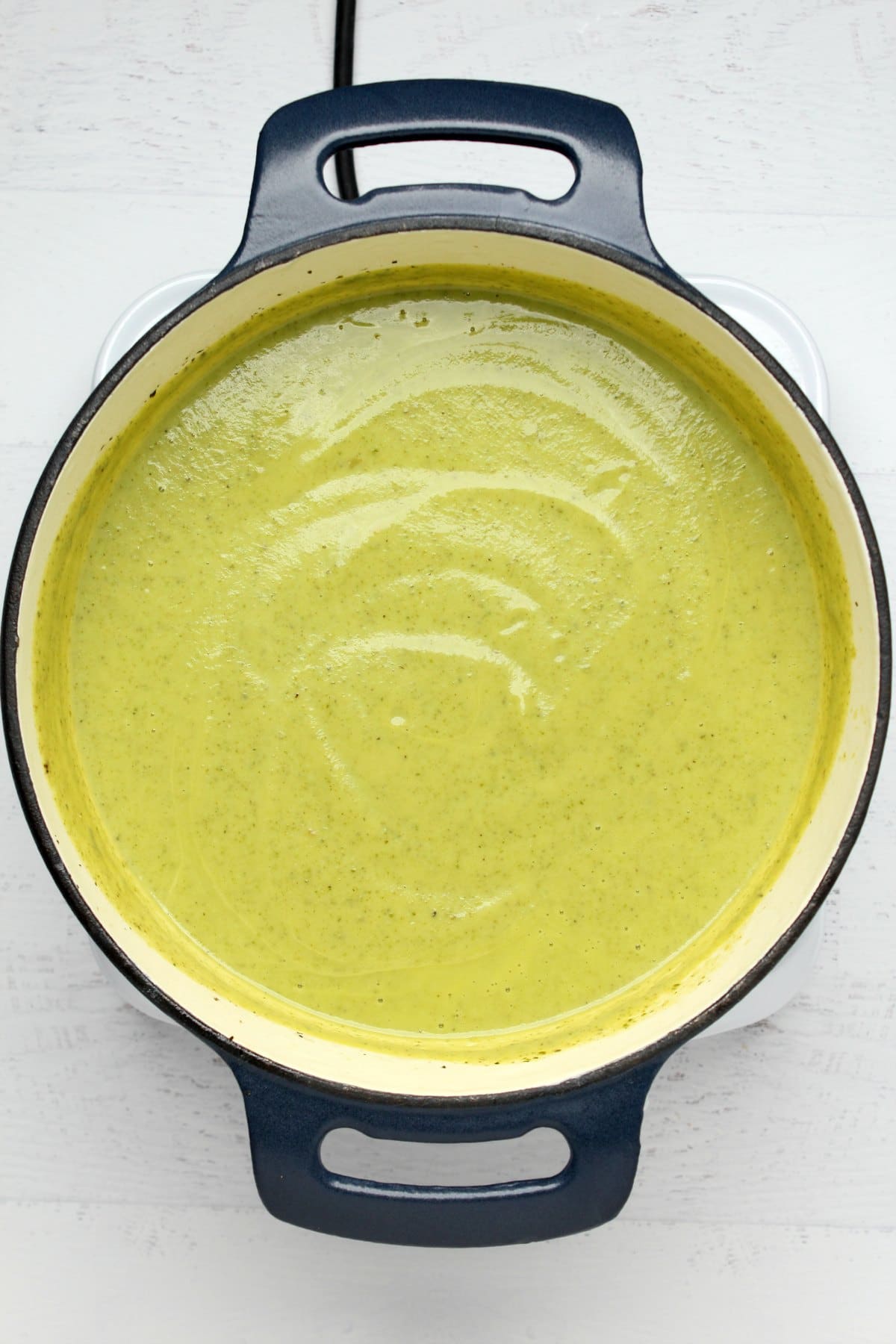 Blended zucchini soup in a pot.