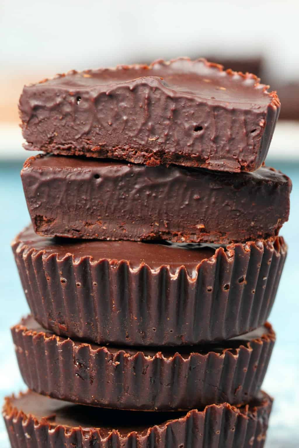 Stack of vegan chocolates with the top one cut in half to show the center. 