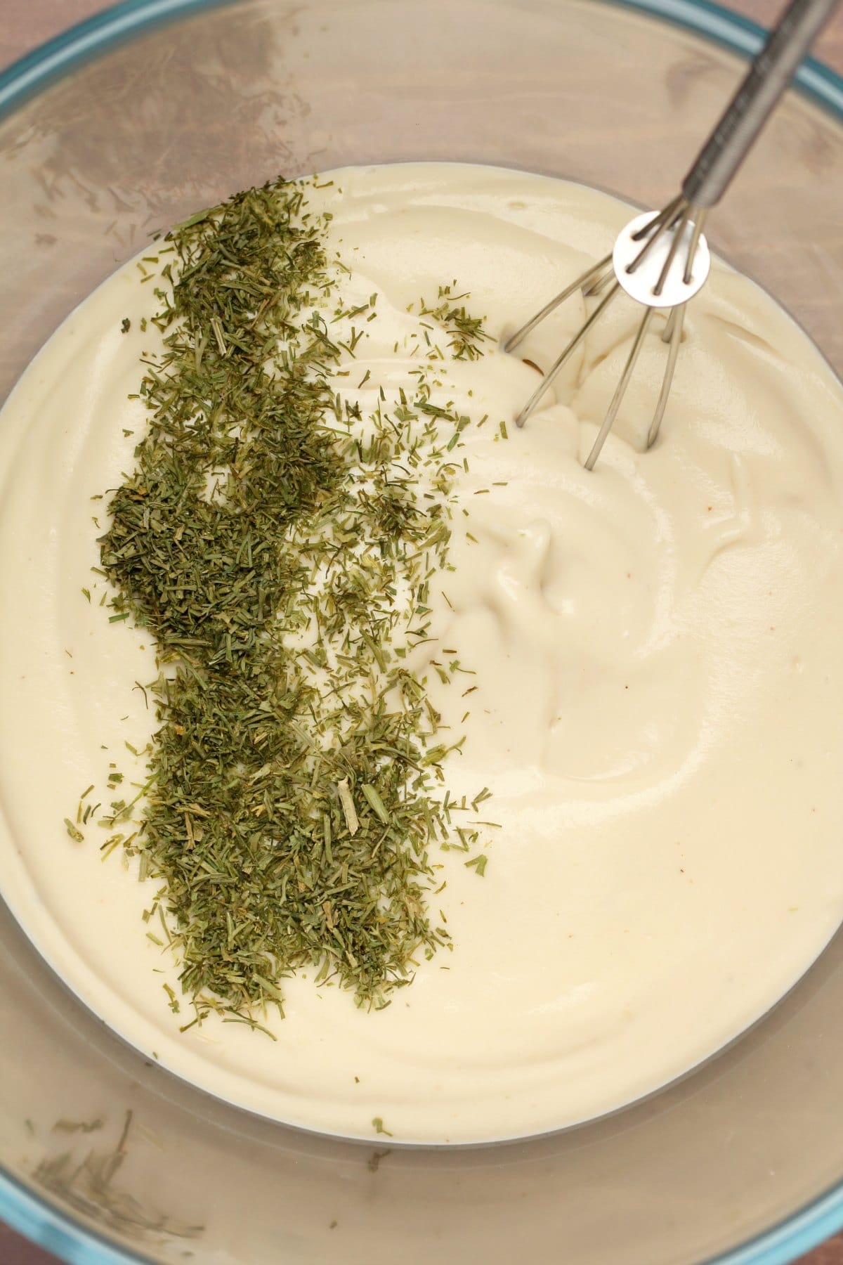 Vegan cream cheese in a bowl with dried dill.