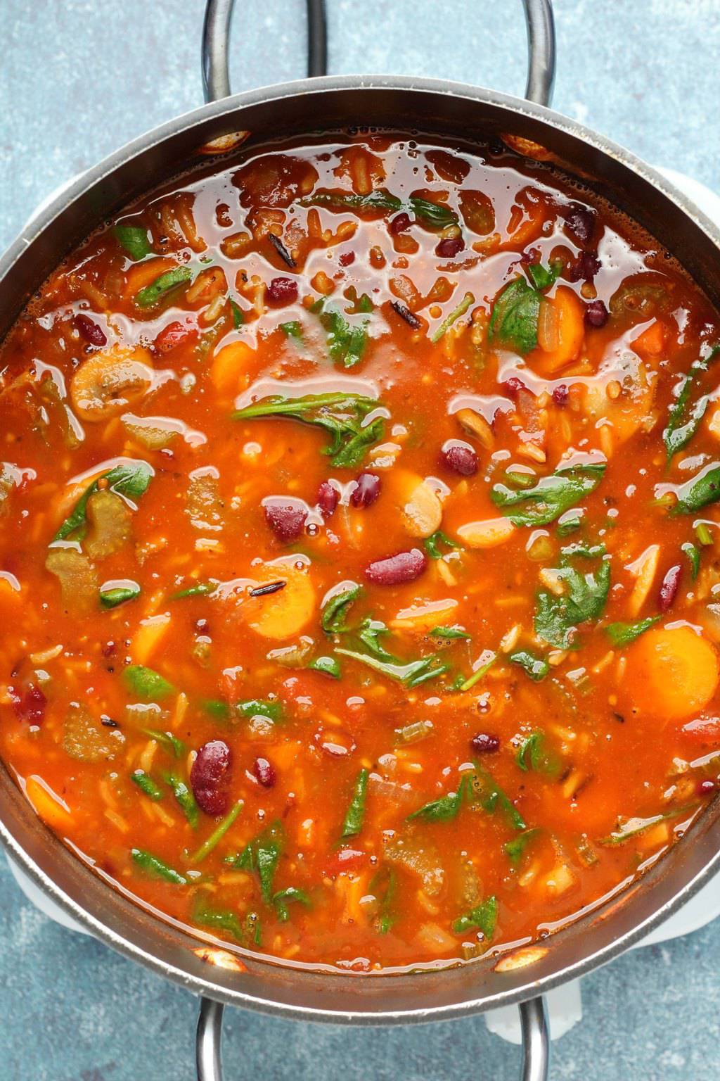 Vegan minestrone soup in a large black pot. 
