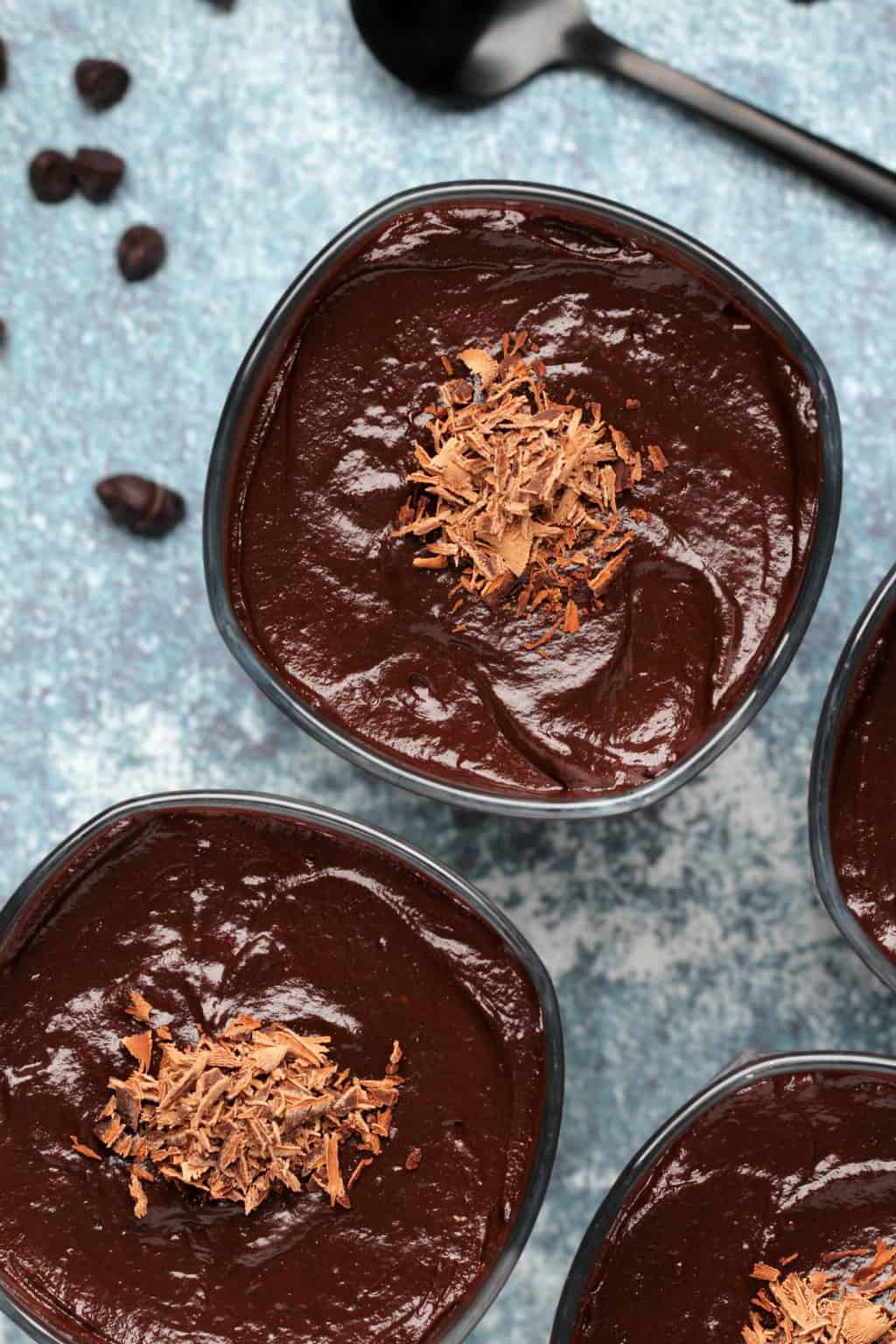 Vegan chocolate avocado mousse topped with chocolate flakes. 