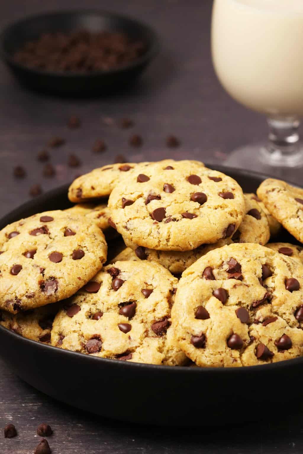 Vegan gluten free chocolate chip cookies in a black bowl. 