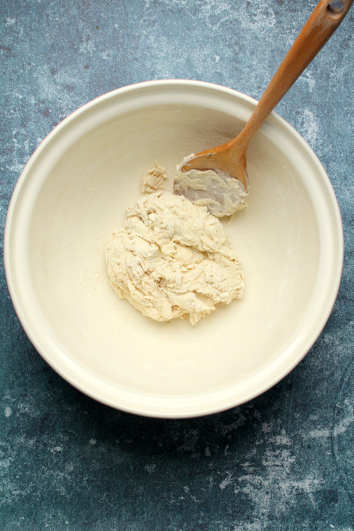 Wet ingredients added to bowl and mixed into a dough.