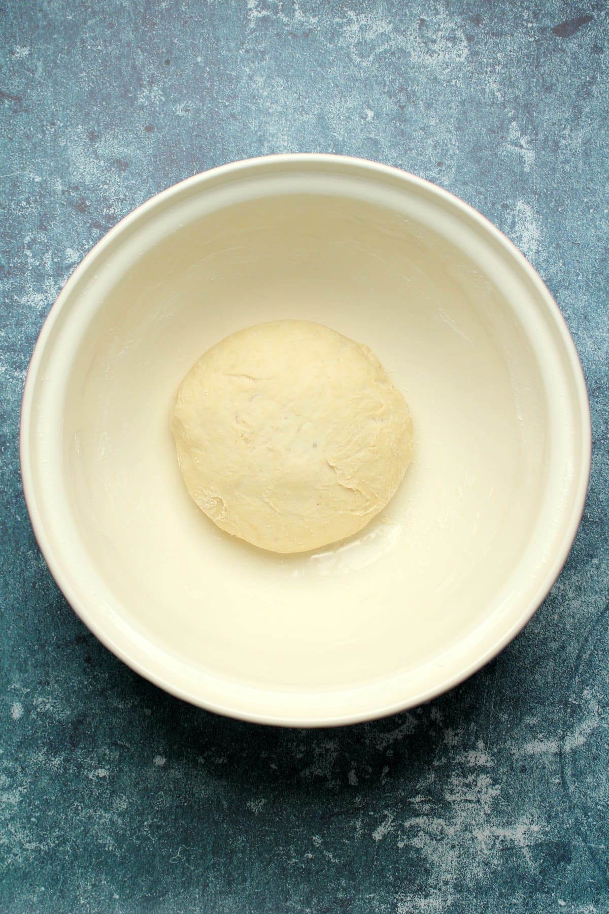 Risen ball of dough in a bowl.