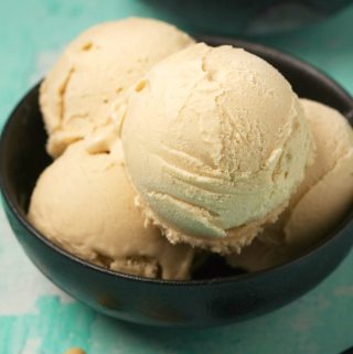 Cashew ice cream scoops in a black bowl