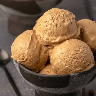 Vegan coffee ice cream scoops in a black bowl.