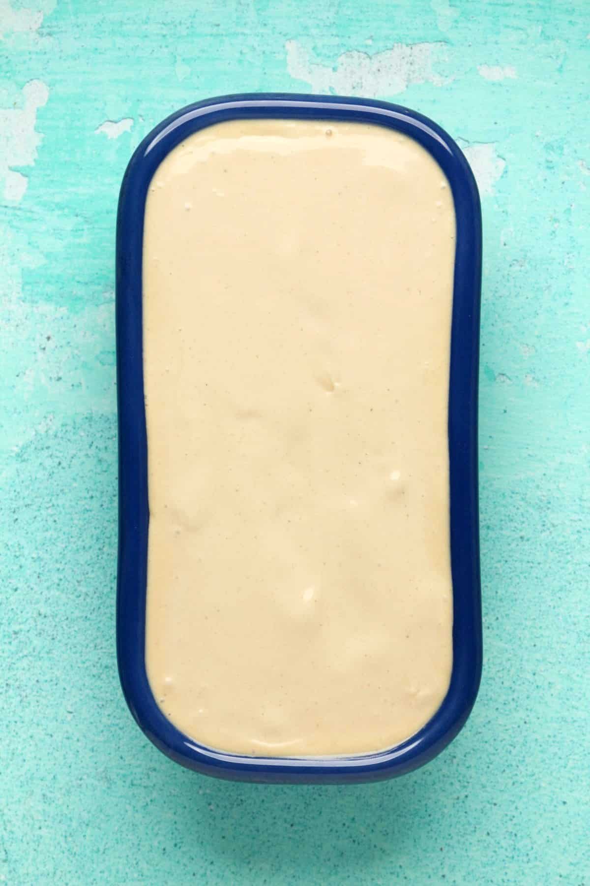 Ice cream mix in a blue loaf pan.