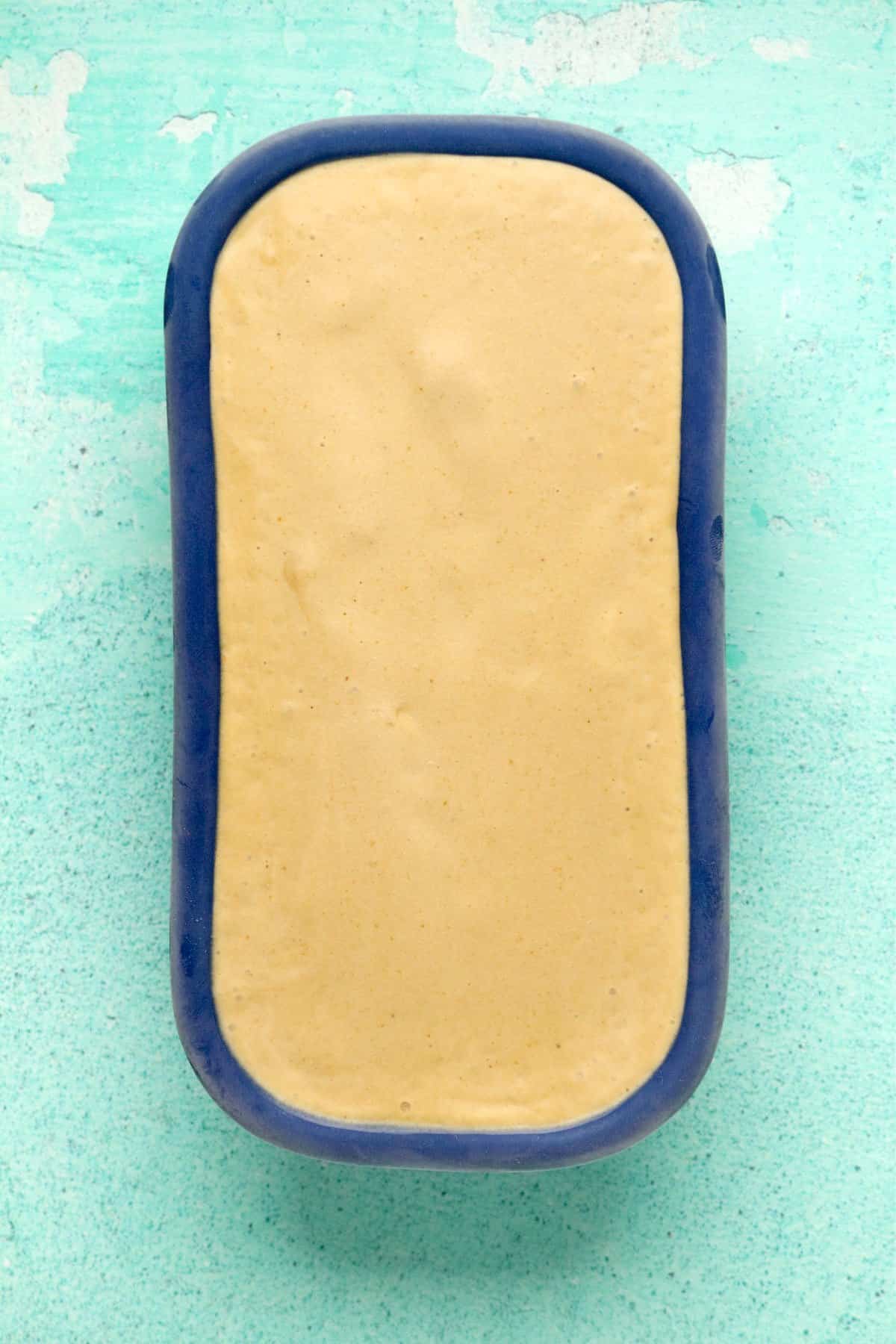 Cashew ice cream in a blue loaf pan.